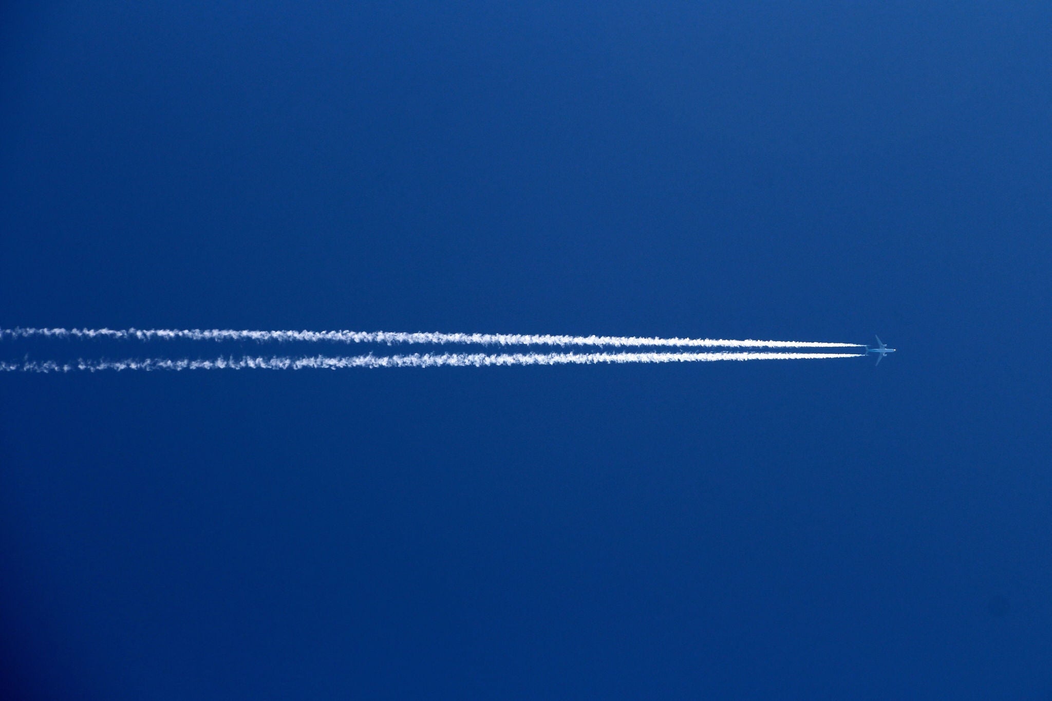 Low Angle View Of Airplane Against Clear Blue Sky