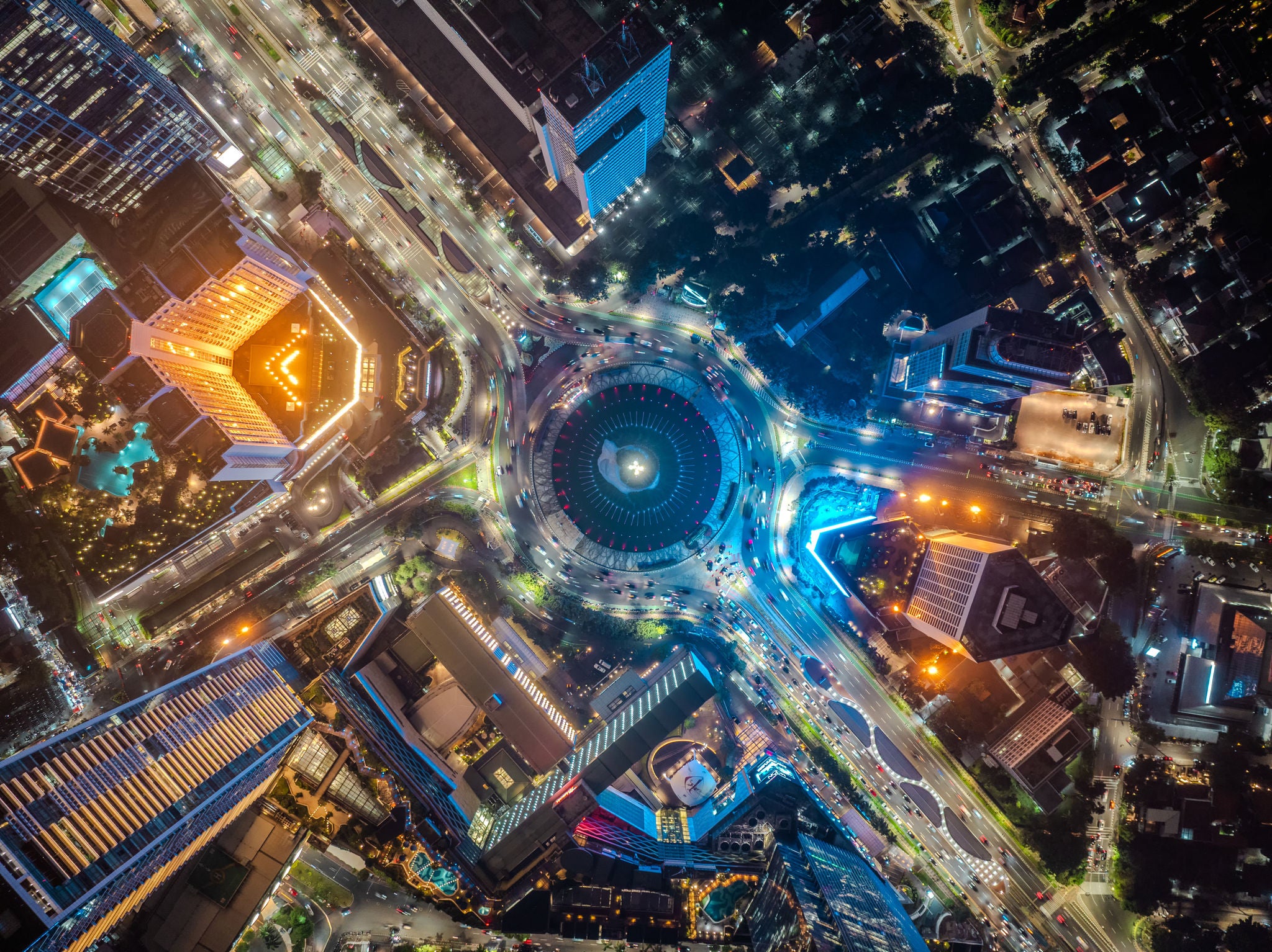 Night aerial view of skyscrapers and multi lane highway in large urban city center Cityscape of high rise buildings in Jakarta, Indonesia at night