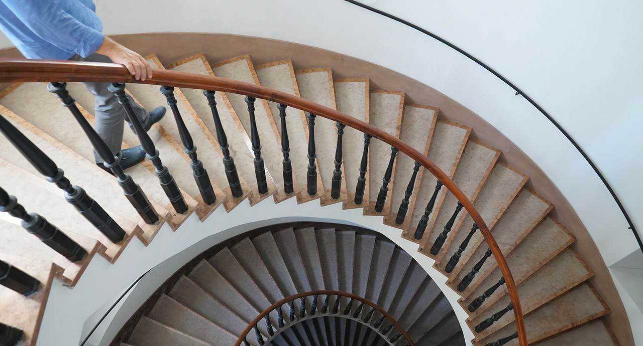 Man going down the interior spiral stairs of luxury modern building, Man going down the interior spiral stairs of luxury modern build