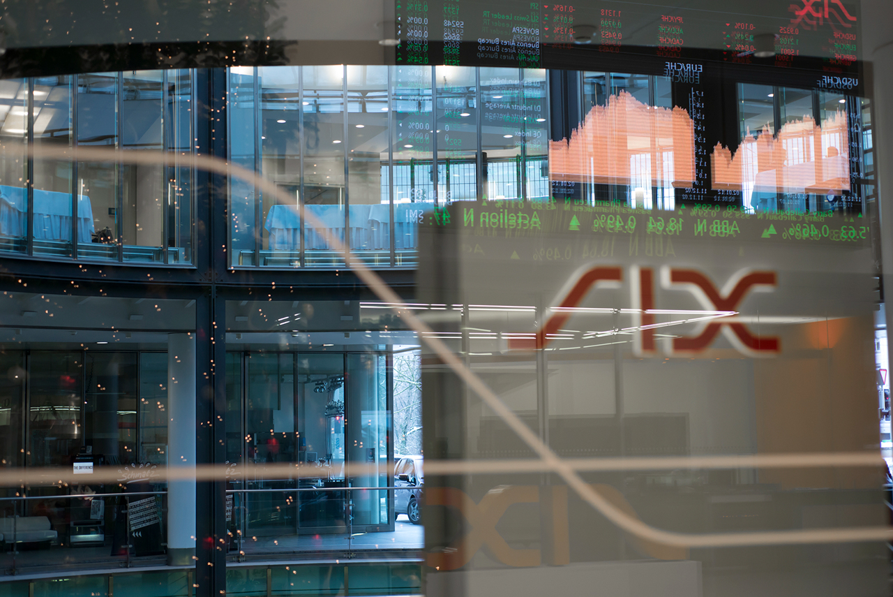 Swiss stock exchange (from 1995 - June 2017) reflected in a window in financial district in Zurich, Switzerland.