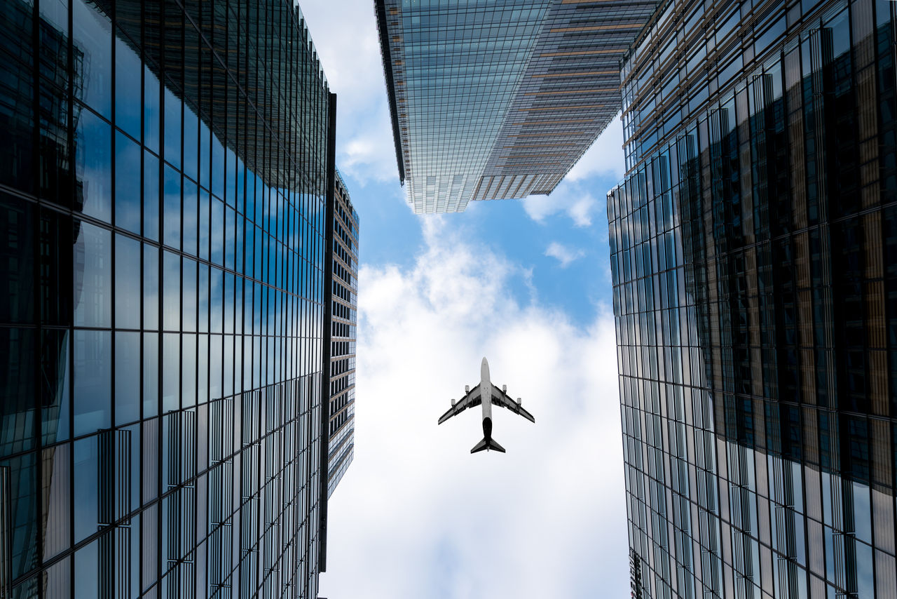 Tokyo skyscrapers buildings and a plane flying overhead at in Tokyo Shinjuku downtown and business district in morning at Tokyo, Japan.