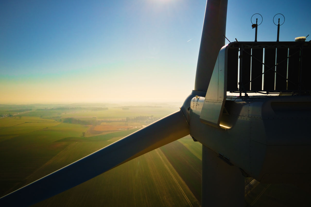 Aerial view of close up windmill turbine in countryside area, Wind power and renewable sustainable energy concept