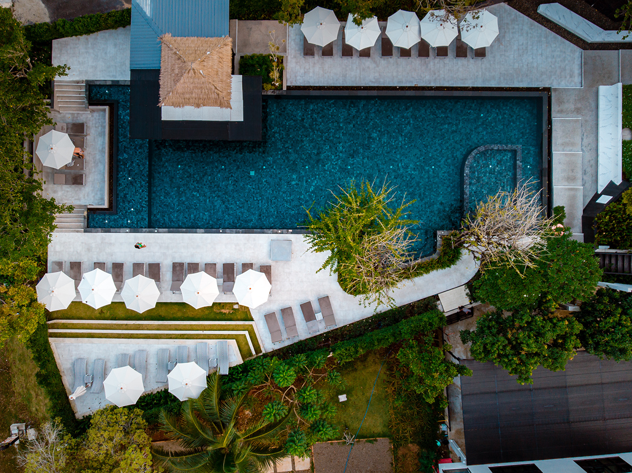 top view swimming pool, drone view pool, couple in swimming pool during vacation in Thailand Asia