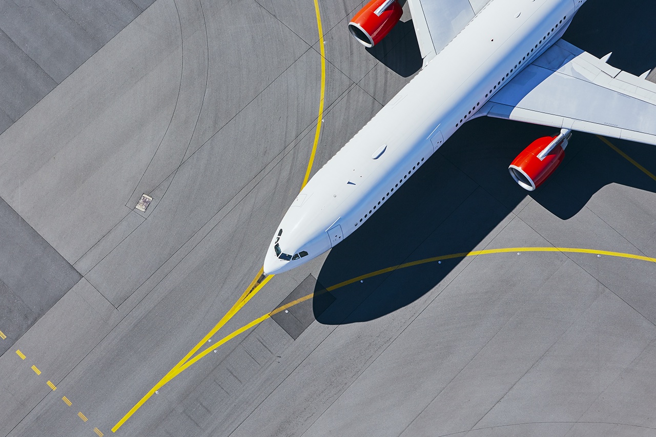 Aerial view of airport. Airplane taxiing to runway before take off.