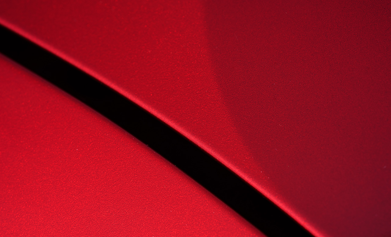 Close up detail of red metallic paint coating car body