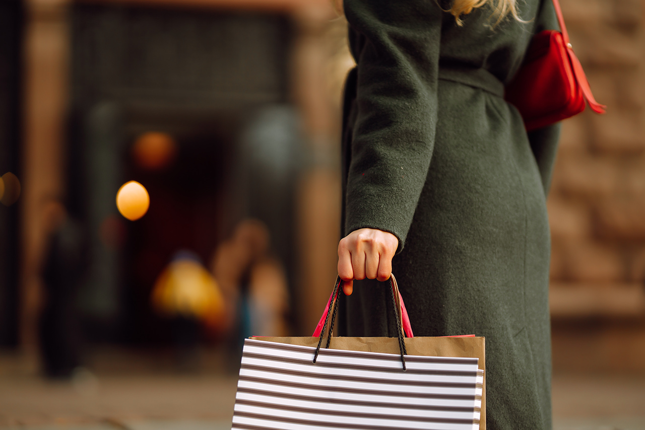 Many Shopping bags in the hand. Autumn shopping. Consumerism, sales, lifestyle concept. Black friday.