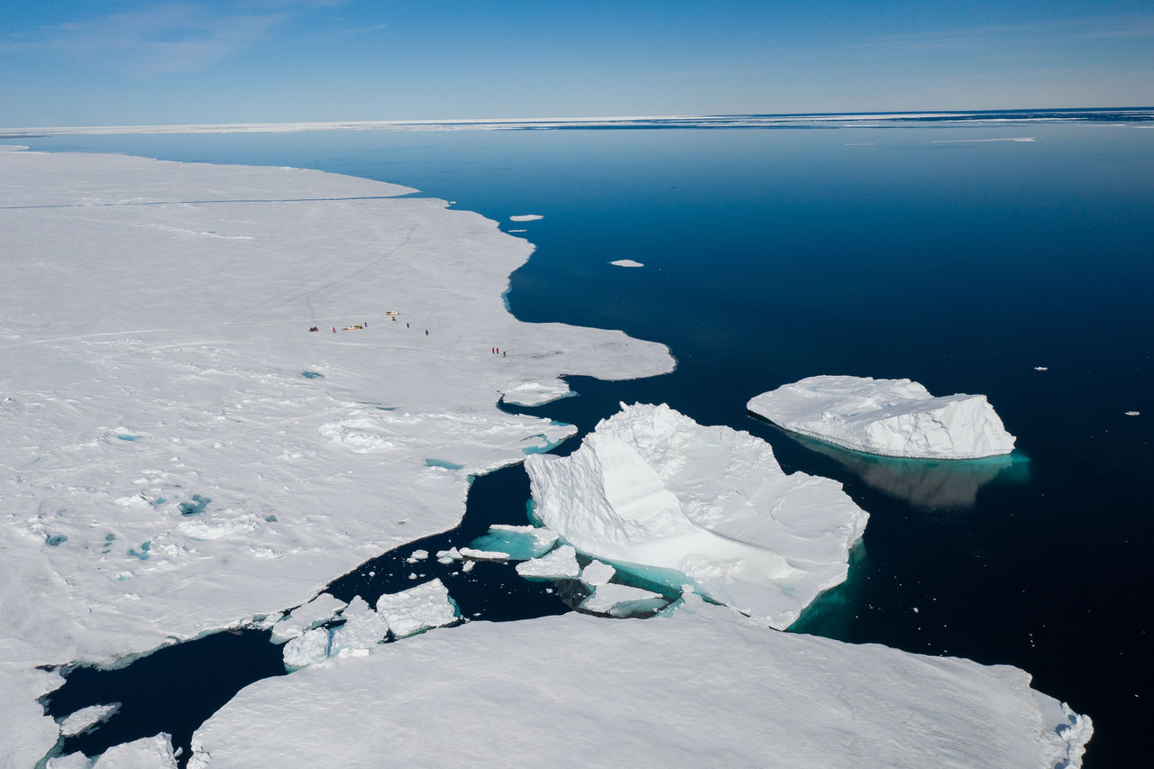 Aerial drone photo of tourists visit the floe edge near Sirmilik National Park in Nunavut, Canada