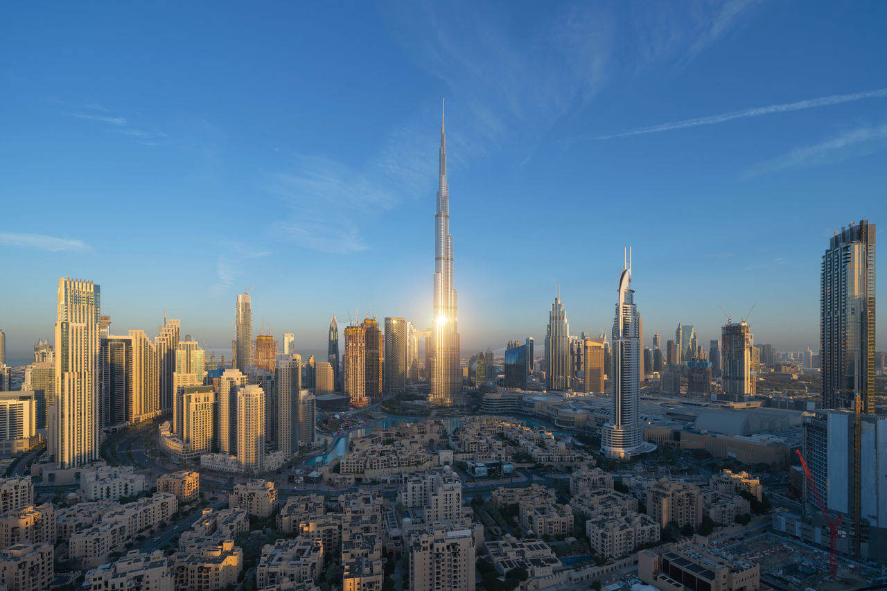 Aerial view of Burj Khalifa in Dubai Downtown skyline and fountain, United Arab Emirates or UAE. Financial district and business area in smart urban city. Skyscraper and high-rise buildings at sunset.