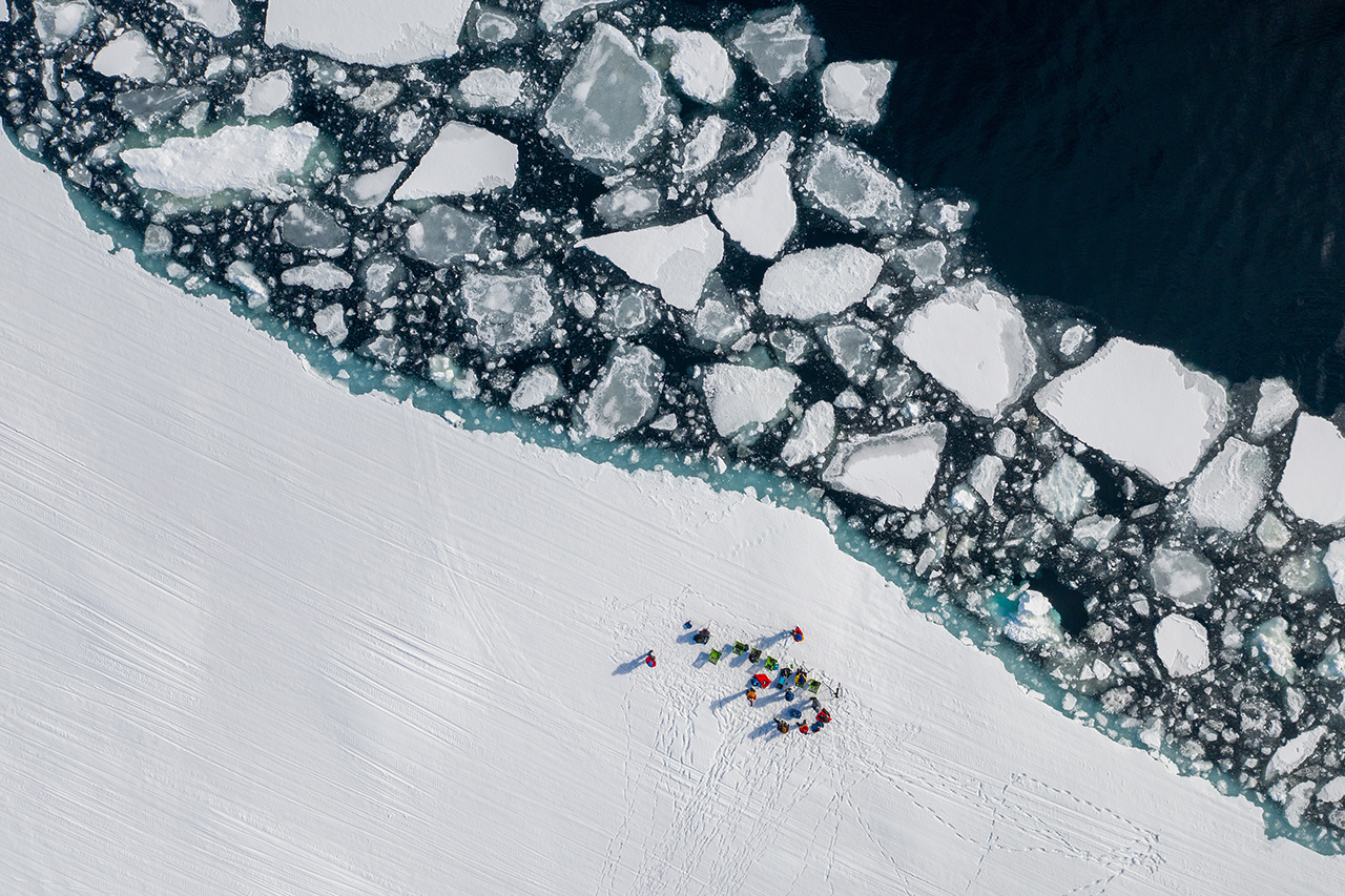 Aerial drone photo of tourists visit the floe edge near Sirmilik National Park in Nunavut, Canada