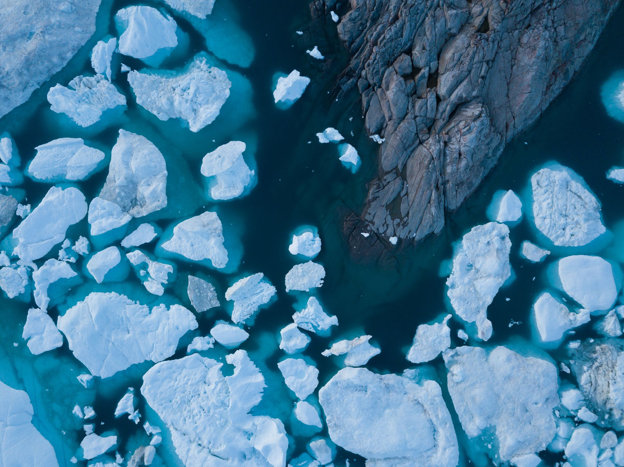 Icebergs drone aerial image top view - Climate Change and Global Warming. Icebergs from melting glacier in icefjord in Ilulissat, Greenland. Arctic nature ice landscape in Unesco World Heritage Site., Icebergs drone aerial image top view - Climate Change and Global