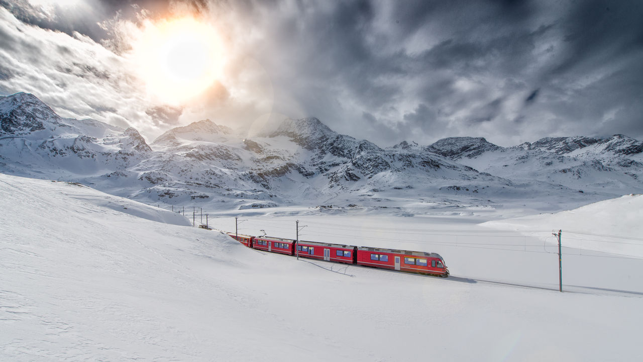 Swiss mountain train Bernina Express crossed through the high mountain snow