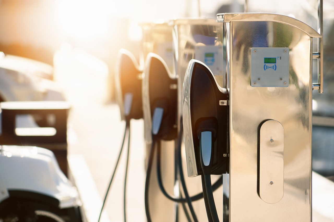 Electric car charging station in luxury marina by the sea