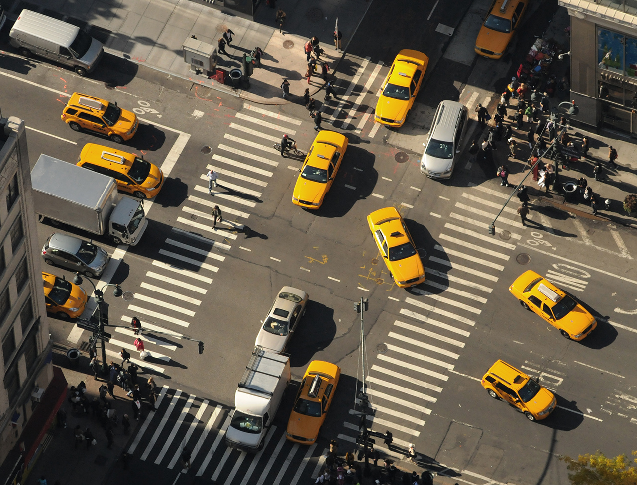 New York City. Yellow cabs go through the intersection. Top view