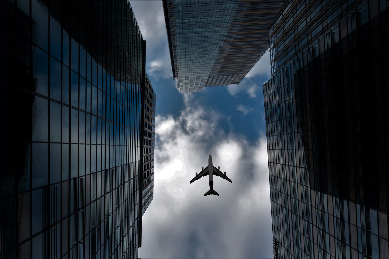 Tokyo skyscrapers buildings and a plane flying overhead at in Tokyo Shinjuku downtown and business district in morning at Tokyo, Japan.