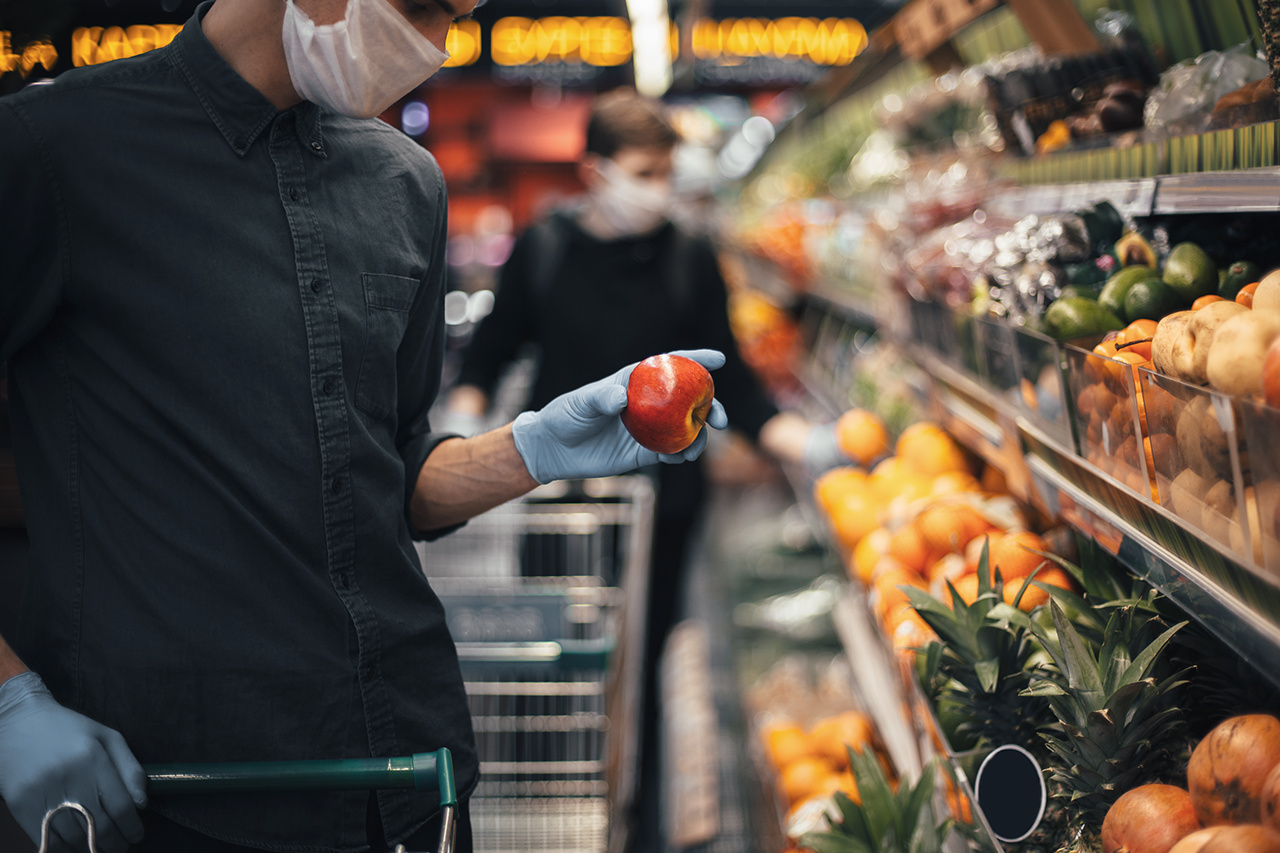 fresh Apple in the hands of a man in protective gloves. hygiene and health care