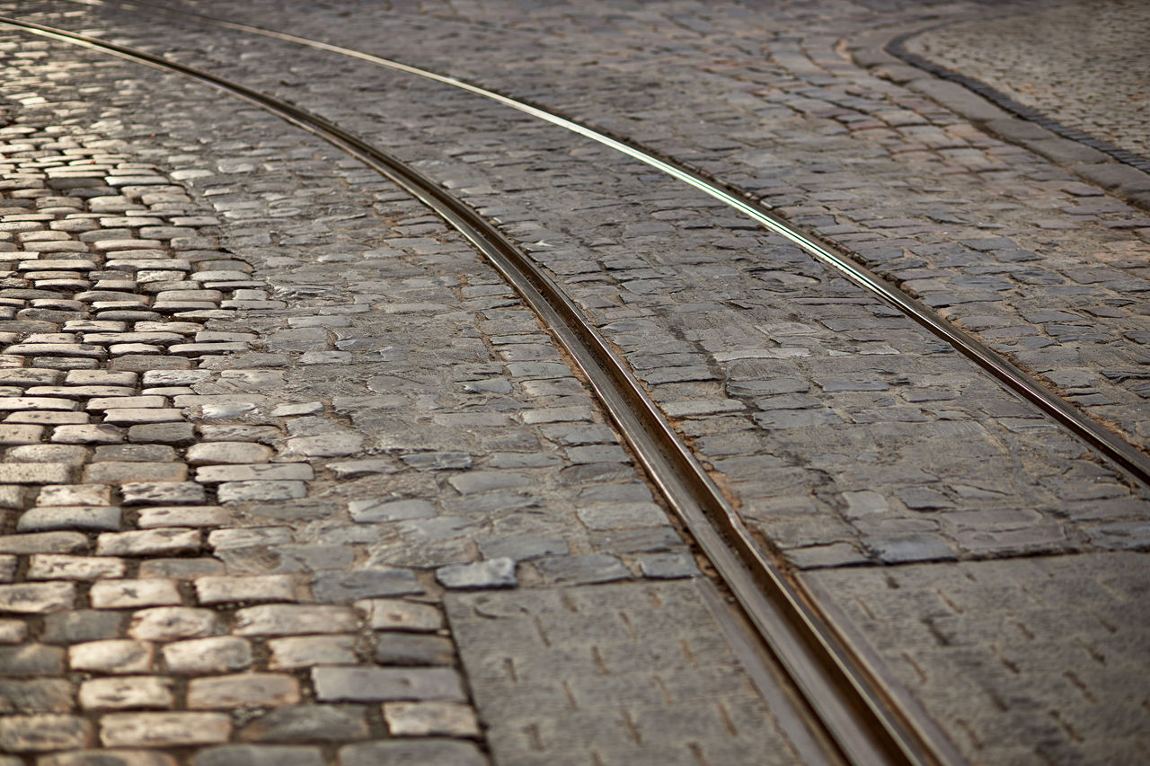 roadway Urban environment Ancient traditional stone paving. stone road carriageway with rails