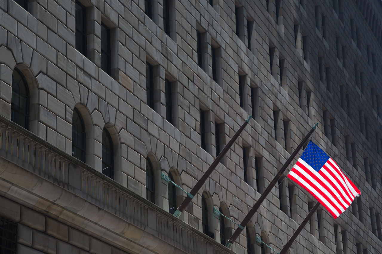 Federal Reserve building & American Flag, New York. Building in shadow with only the american flag in full light, Federal Reserve building & American Flag, New York. Building in 