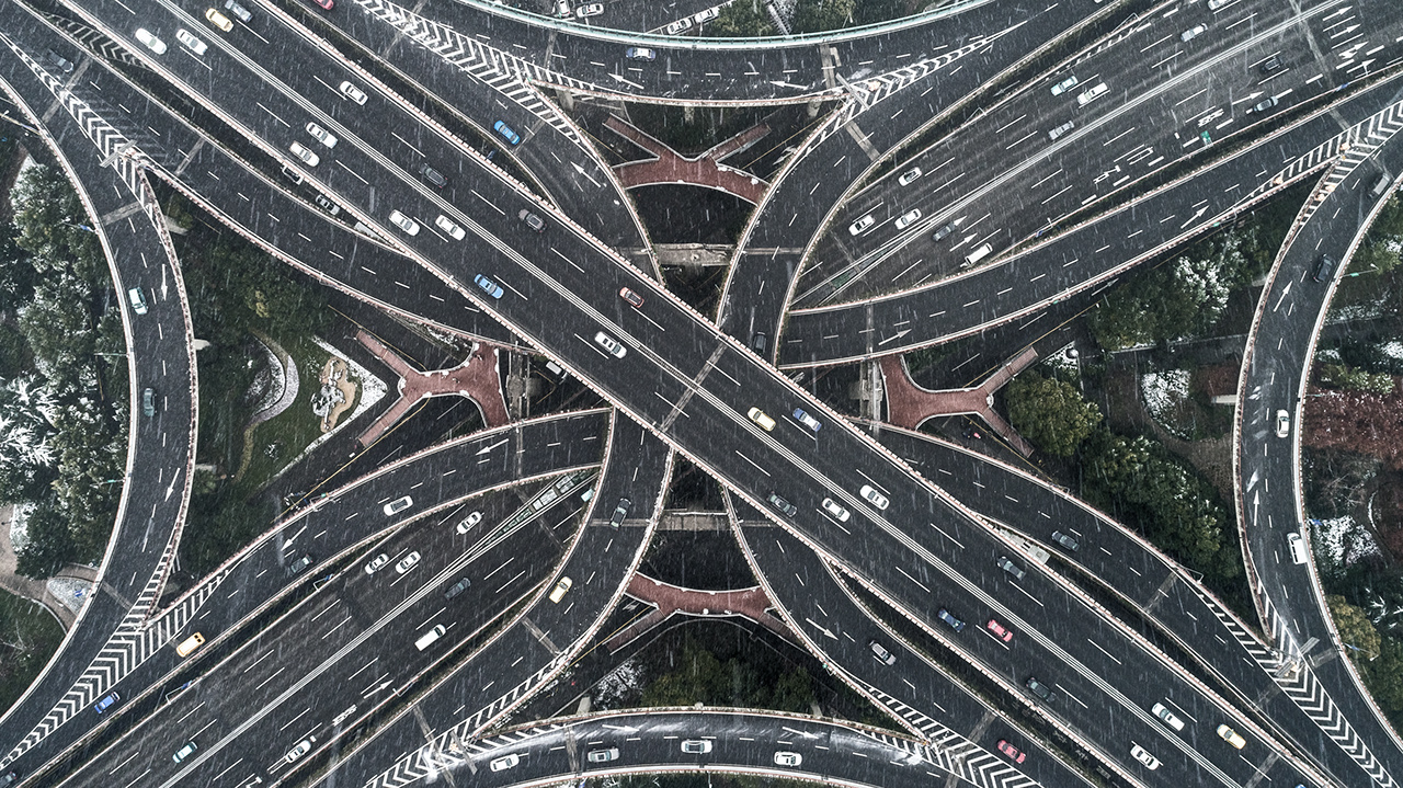 Aerial view of highway and overpass in city on a snowy day